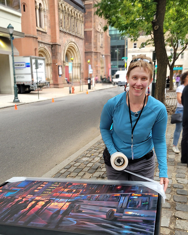 Sarah Pollock wrapping an original painting